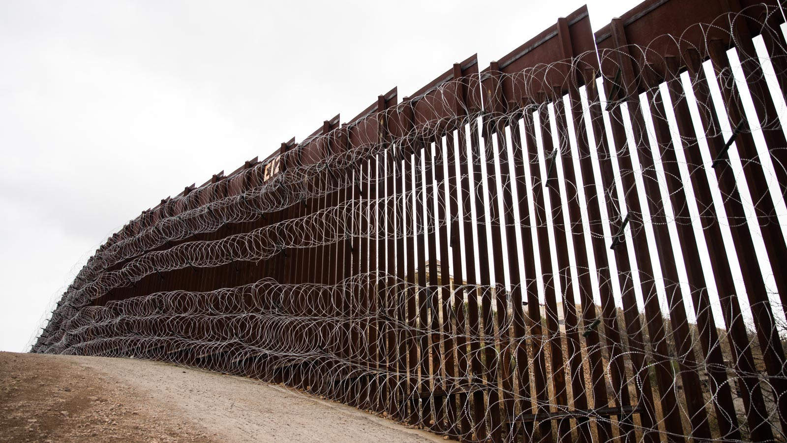 Layers of Concertina are added to existing barrier infrastructure along the U.S. - Mexico border near Nogales, AZ, February 4, 2019. Photo: Robert Bushell